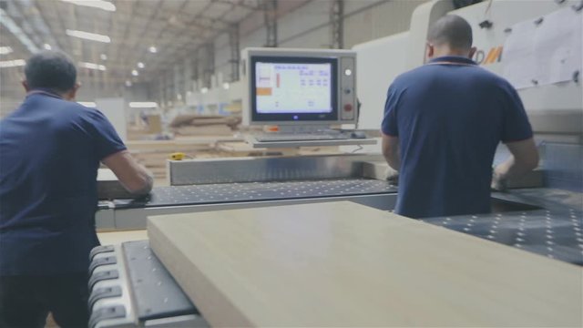Mens work in a factory. Workflow in a furniture factory. Two Asian men work in a furniture factory