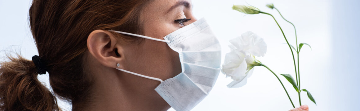 Panoramic Shot Of Woman In Medical Mask Smelling Flowers