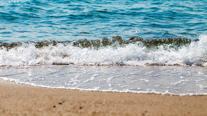 sandy beach and blue sea wave. Beautiful natural background. Tourism and travel.