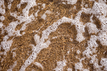Close up sea water waves with bubbles