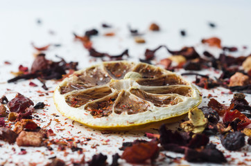 Dried lemon and fruit tea on a light background