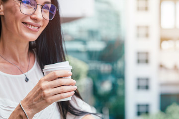 Happiness inside. Beautiful mature woman drinking a cup of coffee on her balcony. Copy space on the...