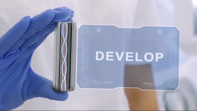 Hand in blue medical glove with a futuristic hud hologram with text Develop. Medical concept of the technology of the future. Doctor with Futuristic Holographic Gadget