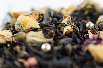 Yellow tea rose with black tea and flowers