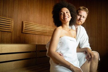 Happy couple having a steam bath in a sauna