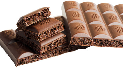 Slices of aerated milk chocolate on white background