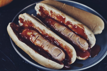 Hot Dog for Halloween. a hot dog sausage in a severed finger in abundance ketchup as blood. Food Ghoul. 