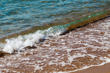 sandy beach and blue sea wave. Beautiful natural background. Tourism and travel.