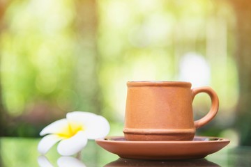 Coffee cup in green garden background - coffee with nature background concept
