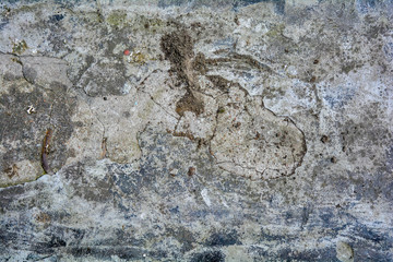 Texture of rough concrete or cement surface with stains of black paint and dirt. Old ruined surface of cityscape