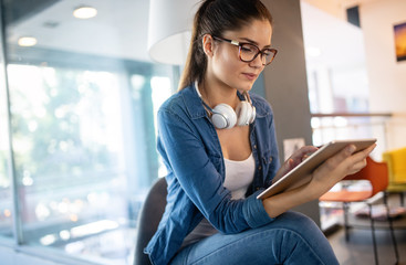Beautiful student girl learning in a library