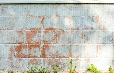 Texture of red corrugated brick wall with white peeling paint. Background image featuring siding brickwork with fluted texture