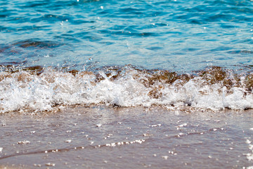 sandy beach and blue sea wave. Beautiful natural background. Tourism and travel.