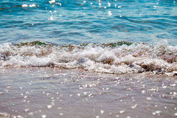 sandy beach and blue sea wave. Beautiful natural background. Tourism and travel.