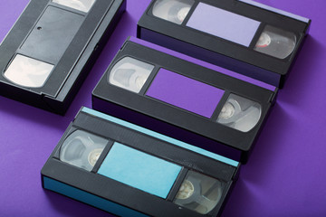 Video cassette on violet background.