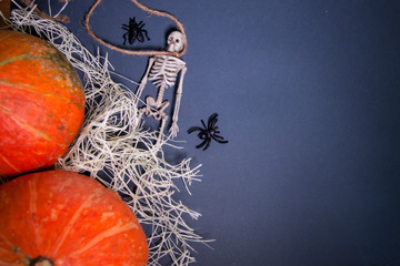 Halloween decorations. Human skeletons on a rope on a dark background. The day of the Dead. Toys ghosts top view. For card and banner