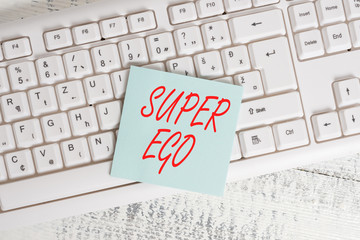 Conceptual hand writing showing Super Ego. Concept meaning The I or self of any demonstrating that is empowering his whole soul Keyboard office supplies rectangle shape paper reminder wood