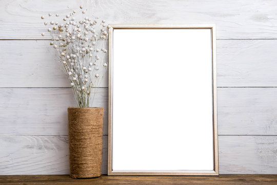Mockup of blank silver frame poster on wall with decor