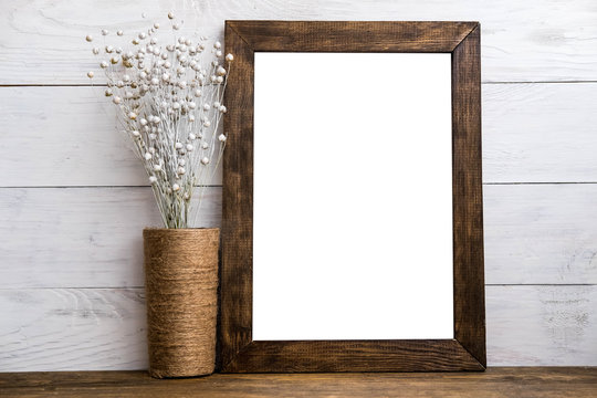 Mockup of blank wood frame poster on wall with decor