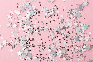 pink background with shiny glitter. silver stars.