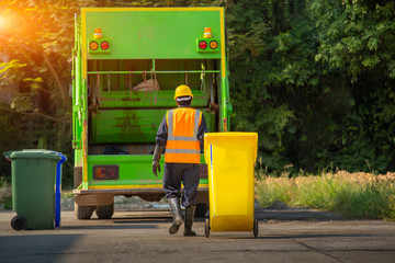 Recyclable garbage truck and the keeper  in the village.