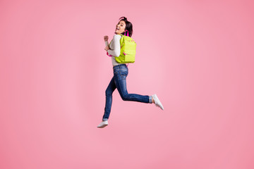 Fototapeta na wymiar Full body photo of crazy lady jumping high holding green rucksack running autumn sale shopping wear pullover and jeans isolated pink color background
