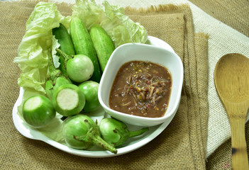 Chili paste and a touch of fresh vegetables cooked in a white dish put on sackcloth. Popular food of Thailand