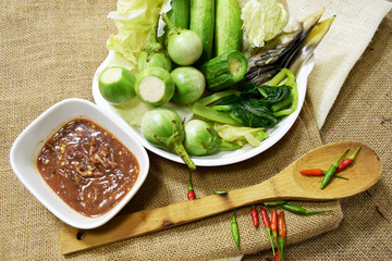 Chili paste and a touch of fresh vegetables cooked in a white dish put on sackcloth. Popular food of Thailand