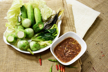 Chili paste and a touch of fresh vegetables cooked in a white dish put on sackcloth. Popular food of Thailand