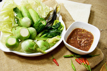 Chili paste and a touch of fresh vegetables cooked in a white dish put on sackcloth. Popular food of Thailand