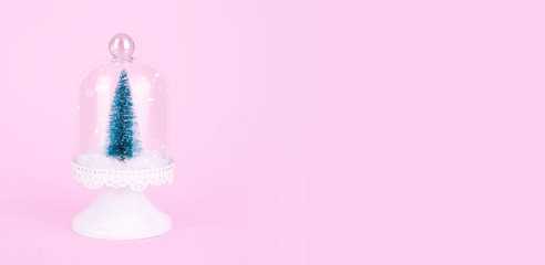 Creative Christmas design on pink pastel color background with Christmas tree.