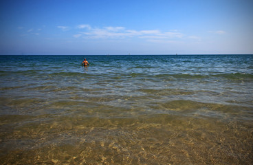 Obraz premium Person bathing in the sea in summer