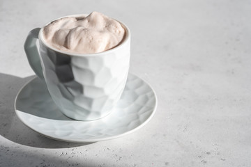 Hot chocolate, decorated with whipped cream and cinnamon
