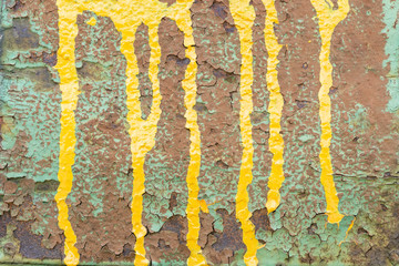 close up of damaged concrete grunge covered with yellow and green colors.