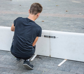 A boy mounting a construction for hockey.