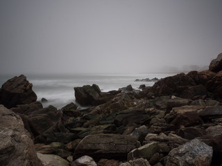 Atlantic Ocean water breakers during Spring with fog background