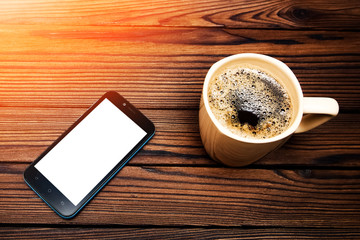 tasty coffee with phone on background