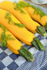 Yellow zucchini with cilantro leaves on a table freshly harvested from my allotment in Nijmegen the Netherlands