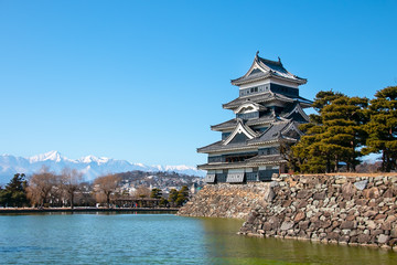 Beautiful landscape of Matsumoto castle, old Japanese castle in autumn with snow moutain background. Landmark and tourist attraction of Matsumoto, Nagano Prefecture, Japan.