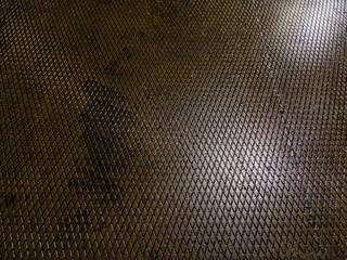 The concrete surface of the concrete slab wet from the rain with the glare of lighting lamps was...