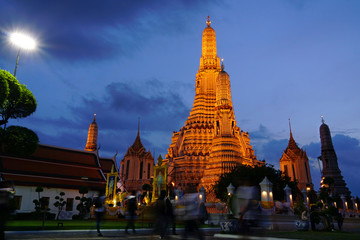 Fototapeta premium Ancient buddhism pagoda of wat Arun temple in blue hour sunset scene time sky, famous landmark of Bangkok, Thailand, southeast asia.