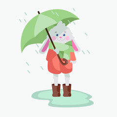 Vector illustration with a little bunny in brown rubber boots, a big green scarf and a pink coat. A rabbit is standing in the pouring rain in a puddle with an umbrella.