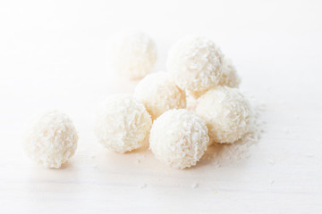 Fototapeta na wymiar coconut candy in coconut flakes on a white background