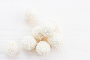 Fototapeta na wymiar white round coconut candies with coconut flakes