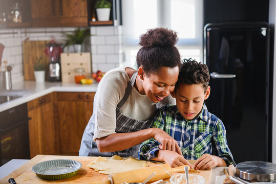 Mother and son baking together. American family. Single mother. Child helping mother. - Powered by Adobe