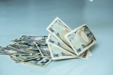Japanese currency flown to the floor and stack of Japanese yen note
