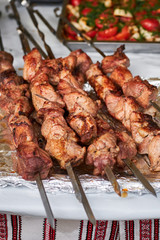 barbecue meat on skewers. grilled meat on open grill. street food