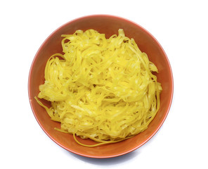 yellow noodles on bowl isolated on white background