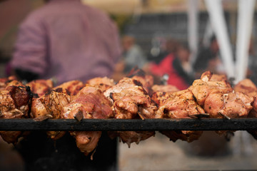 barbecue meat on skewers. grilled meat on open grill. street food