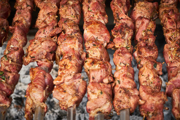 barbecue meat on skewers. grilled meat on open grill. street food